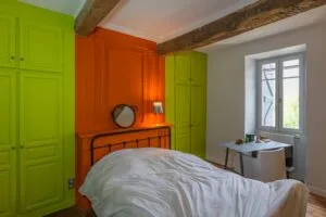 Artisan peintre l'isle-jourdain 1 - Medale Peinture poutres apparentes en bois brut dans une chambre aux placards vert anis et à la boiserie orange